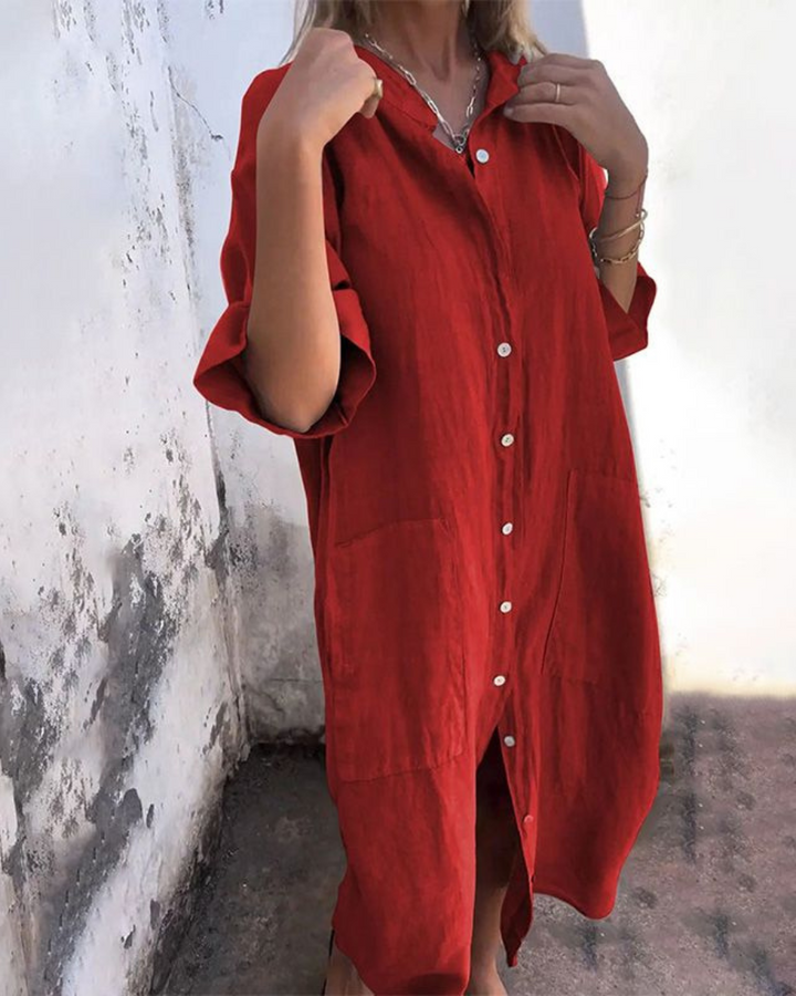 Front view of a model wearing a red cotton casual midi dress with white buttons and two front pockets
