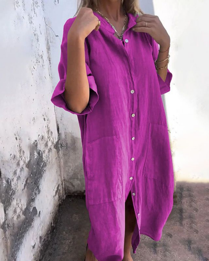 Front view of a model wearing a purple cotton casual midi dress with white buttons and two front pockets