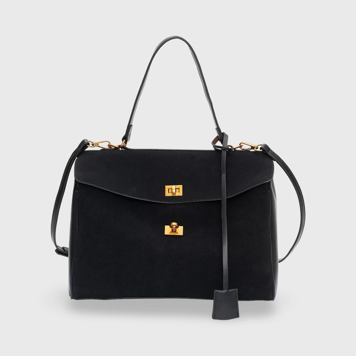Front view of a black vegan leather and suede premium shoulder bag with gold hardware and a key tag