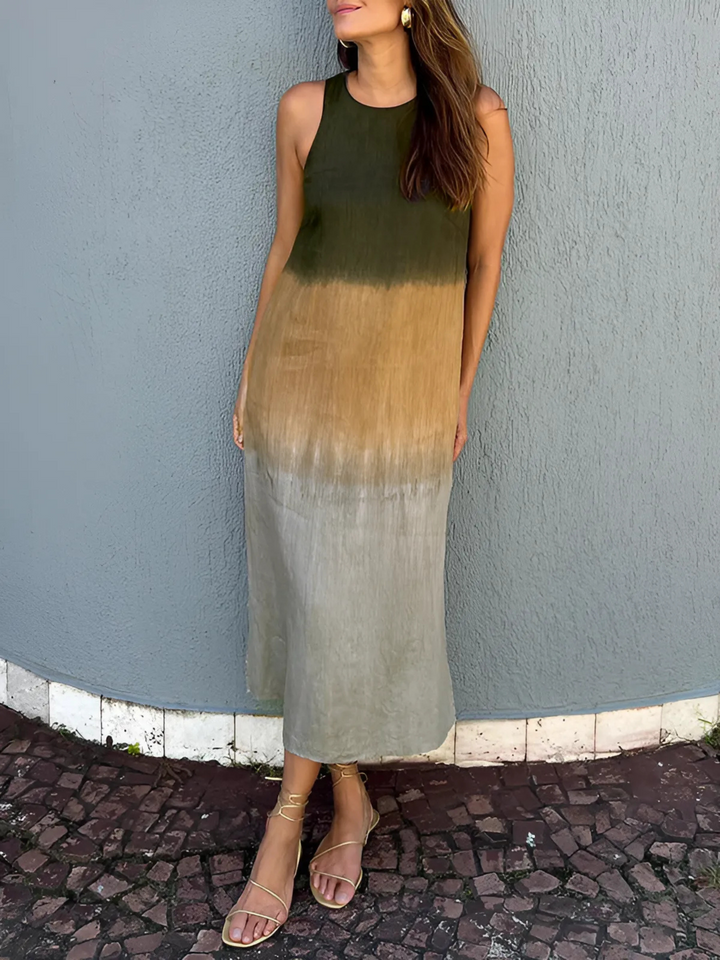 Willa Printed Dress worn by model, a sleeveless midi dress with a dark brown to light brown ombre print and gold sandals