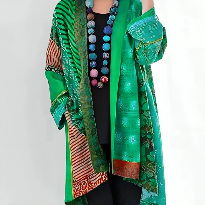 Elisa coat worn by model, three quarter front view, showing green patterned fabric over black top and pants