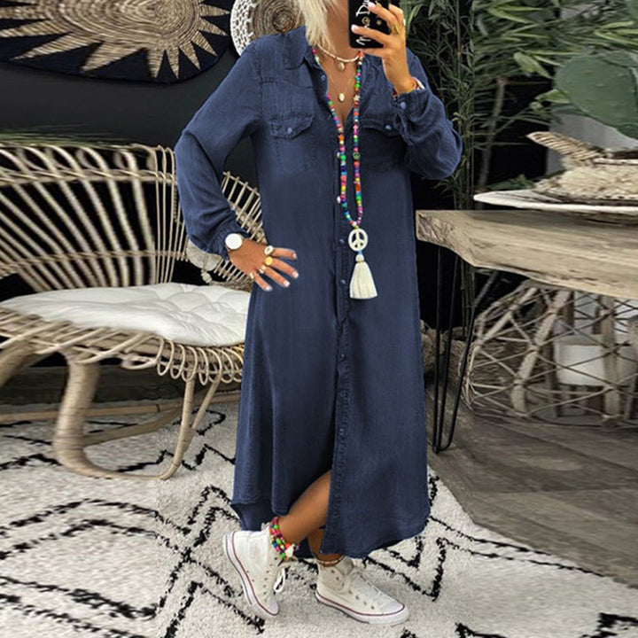 Front view of a model wearing a long sleeve denim maxi dress with an open button front and white sneakers