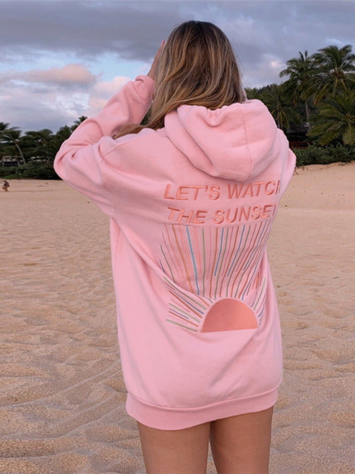 Back view of model wearing an oversized graphic print hoodie with "LET&