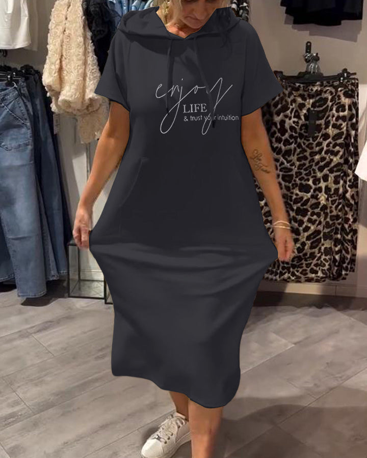 Front view of a model wearing a navy hooded sweatshirt dress with &