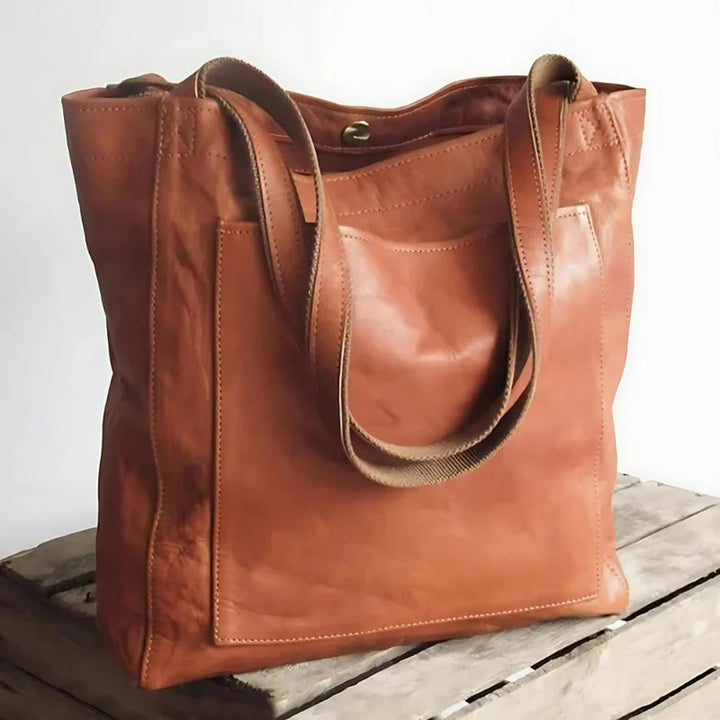 Front view of the Josie leather handbag in a rich tan colour with a canvas shoulder strap