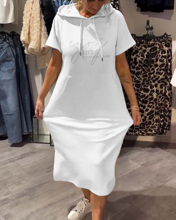 Front view of a model wearing a cream hooded sweatshirt dress with &