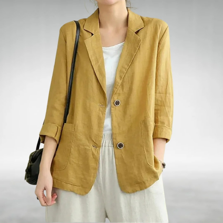 Front view of a model wearing a mustard yellow casual chic blazer with two buttons and rolled up sleeves