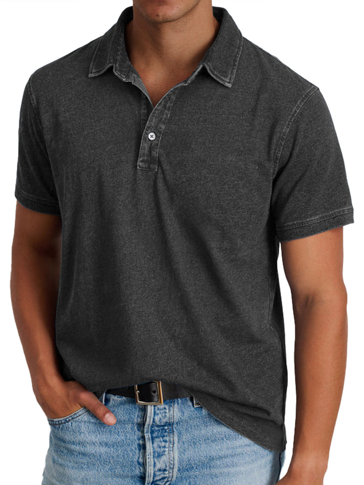 Front view of a man wearing a charcoal 100% cotton collared polo shirt with light wash denim jeans