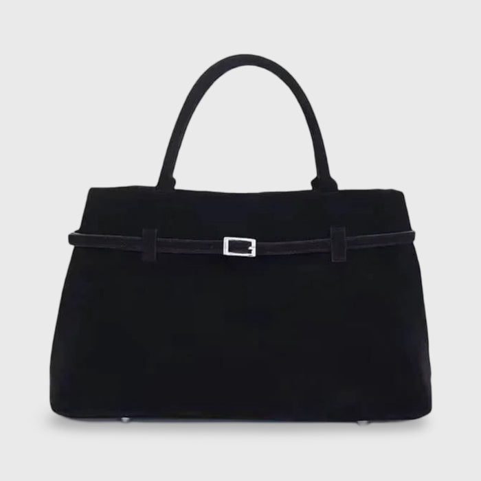 Front view of the black suede Sara handbag with two top handles and a silver buckle detail on a plain background