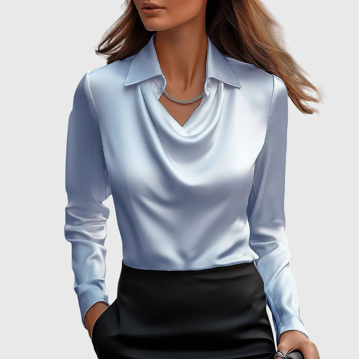 Front view of a model wearing the Autumn Satin Vintage Long Sleeve Blouse in silver with a black skirt