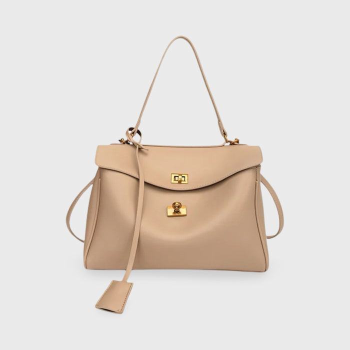 Front view of the Ciara vegan leather shoulder bag in beige with gold hardware and a long key fob