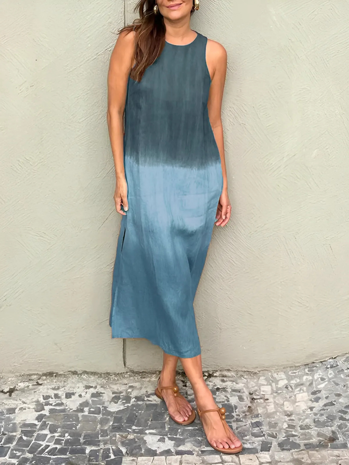 Willa Printed Dress worn by model, a sleeveless midi dress with a dark blue to light blue ombre print