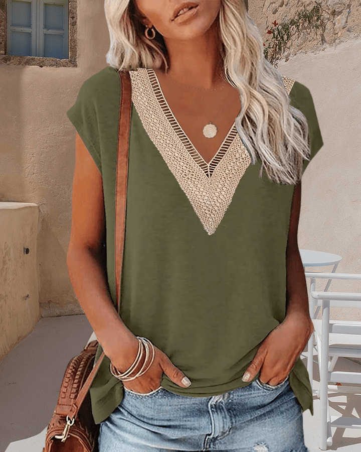 Front view, model wearing an olive V-neck lace t-shirt with light wash denim shorts and a brown shoulder bag