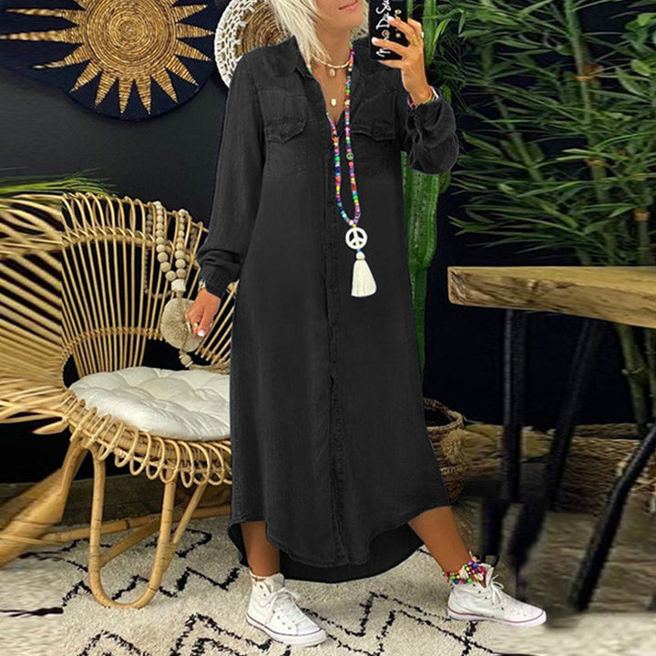 Black long sleeve maxi dress with a high low hem and white trainers