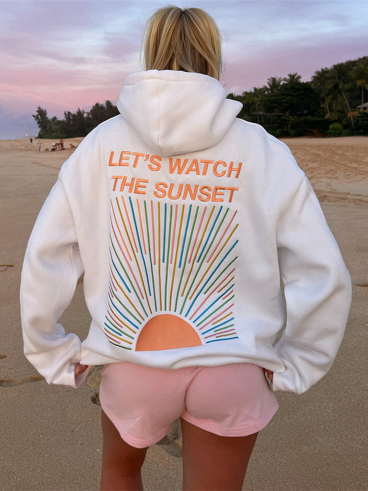 Back view of model wearing an oversized graphic print hoodie with "LET&