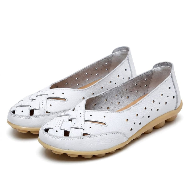 Three quarter view of white breathable leather loafers with woven toe and perforated sides