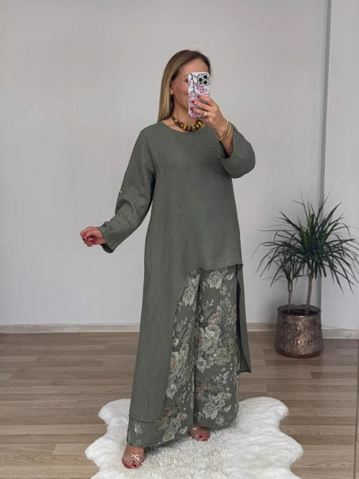 Front view of a model wearing a long-sleeve top and floral printed pants set, holding a phone