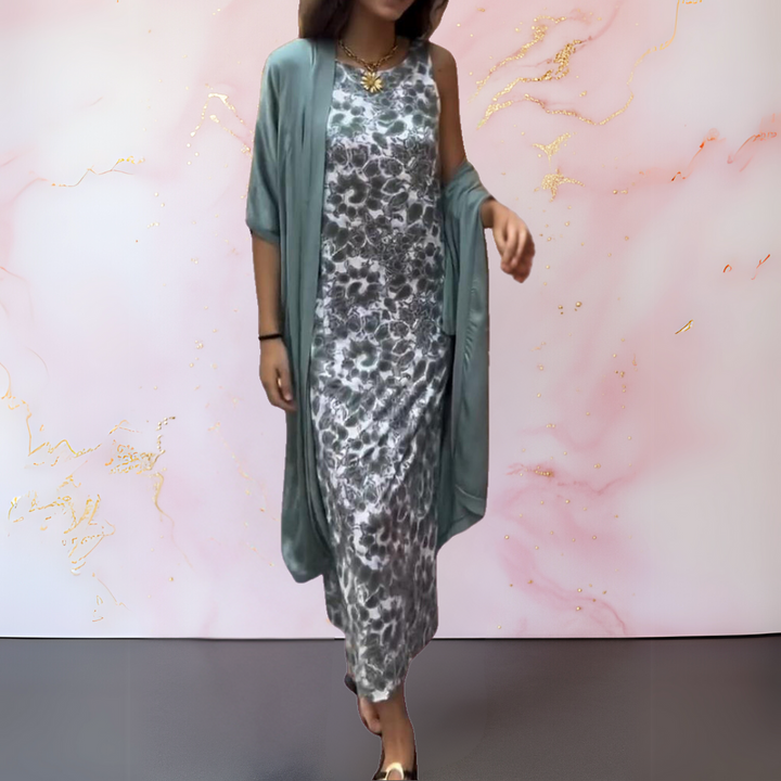 Front view of a model wearing a floral print boho maxi dress and a flowing sage green cardigan