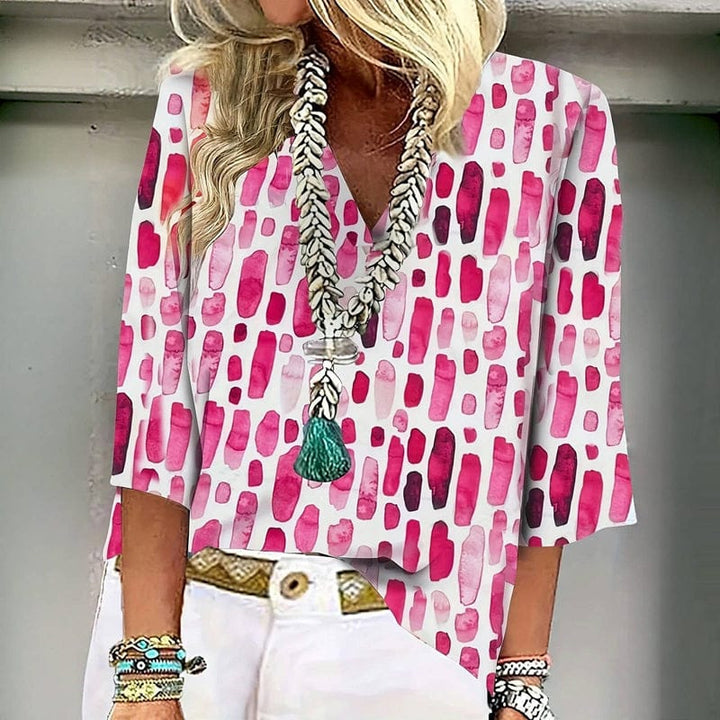 Close up of a woman wearing a vintage casual blouse with pink abstract print and seven-quarter sleeves