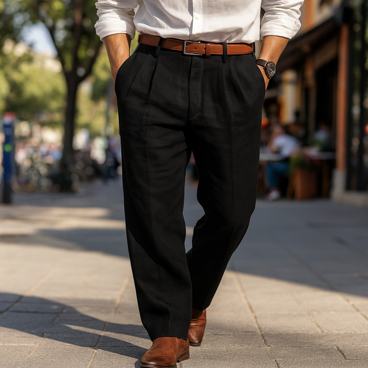 Front view of a model wearing classic cotton linen pants in black, walking on a paved street