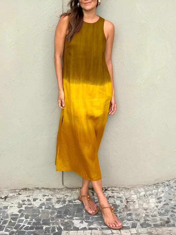 Willa Printed Dress worn by model, a sleeveless midi dress with a dark brown to golden yellow ombre print and sandals