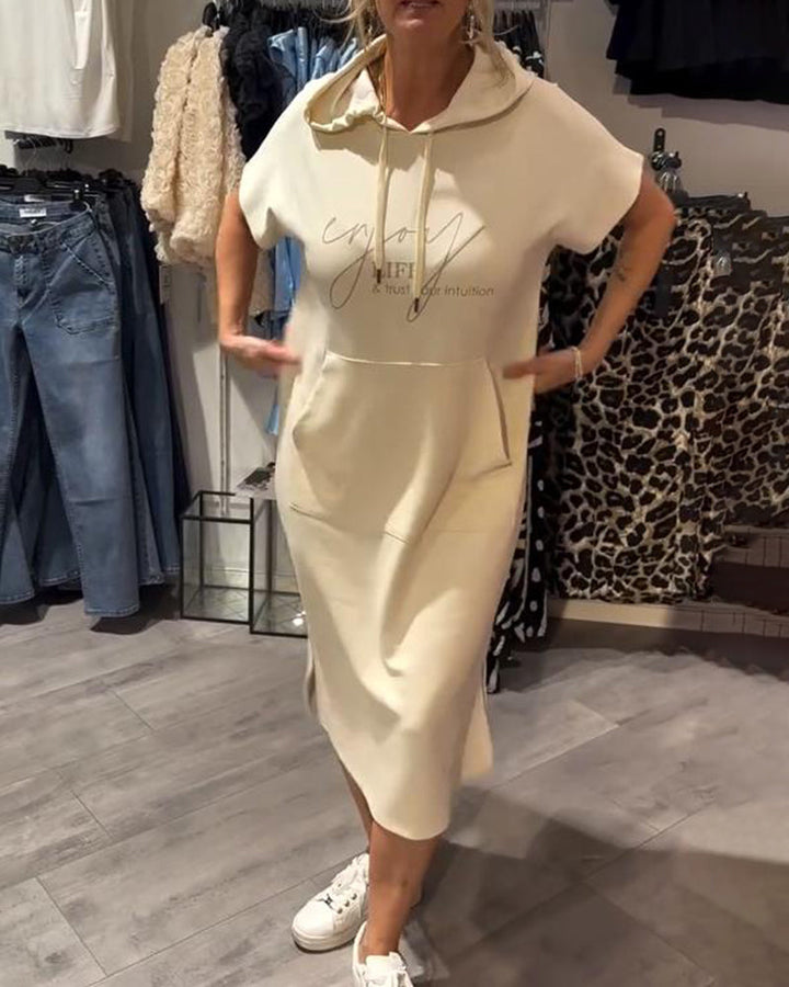 Front view of a model wearing a cream hooded sweatshirt dress with &