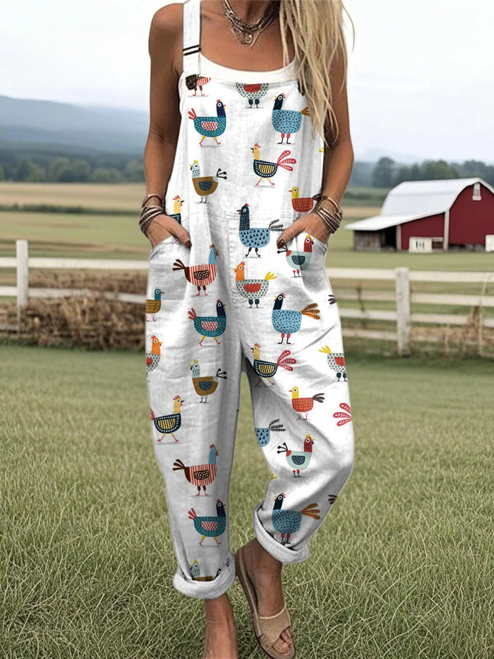 Front view of a model wearing a white cotton wide leg jumpsuit with a colourful chicken pattern