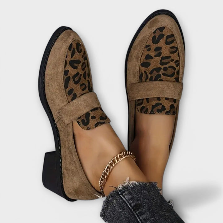 Leopard Print Flats worn by model, showing the front of both Pia shoes and a gold anklet