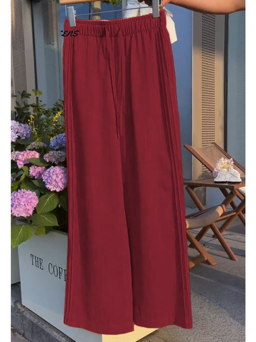 Back view of dark red Tencel linen wide leg casual pants with an elasticated waist and drawstring