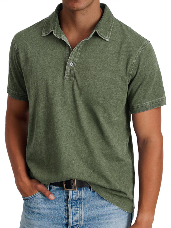 Front view of a man wearing an olive 100% cotton collared polo shirt with light wash denim jeans