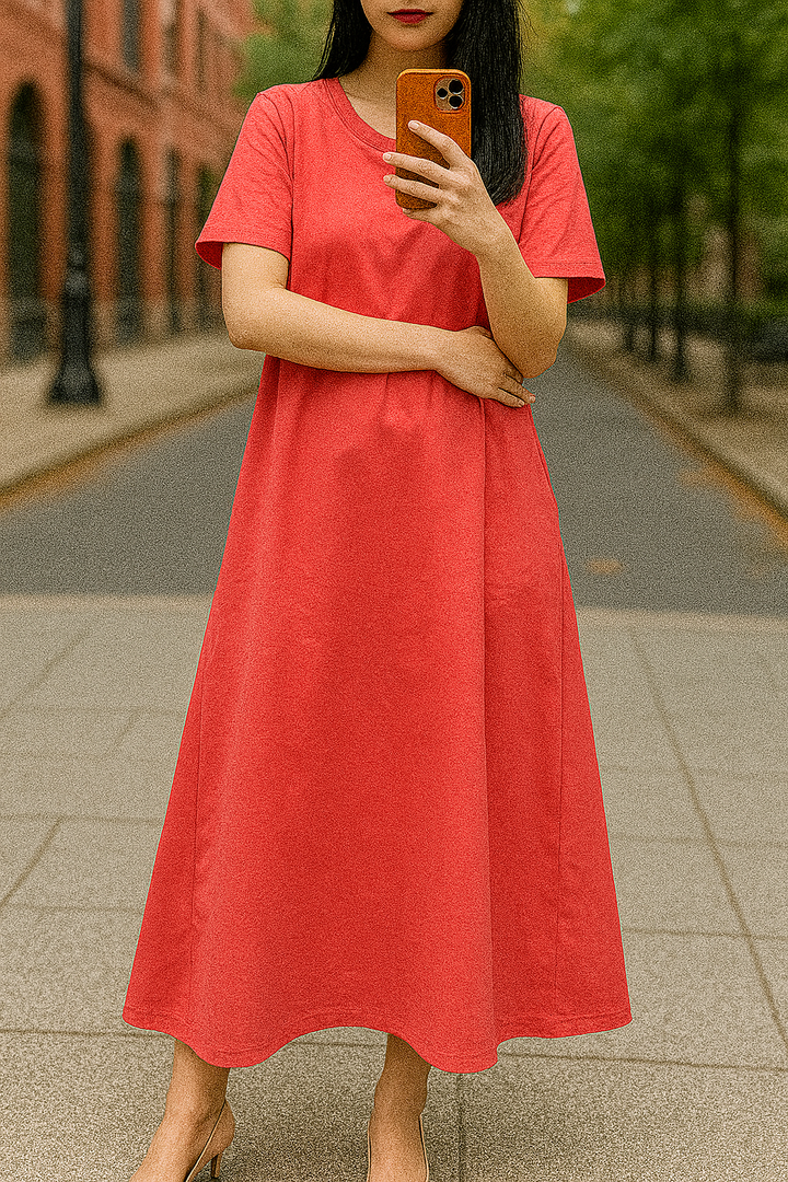 Front view, worn by model, of a flowing maxi dress in a vibrant red colour with a round neck and short sleeves