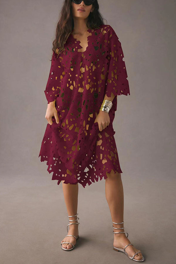 Front view of a model in a burgundy floral eyelet lace midi beach cover up dress and silver sandals