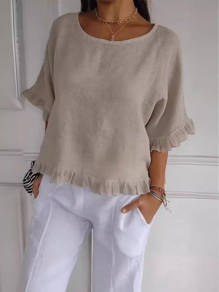 Close up, Zelda casual elegant blouse in beige with ruffle detail on sleeves and hem, worn by model