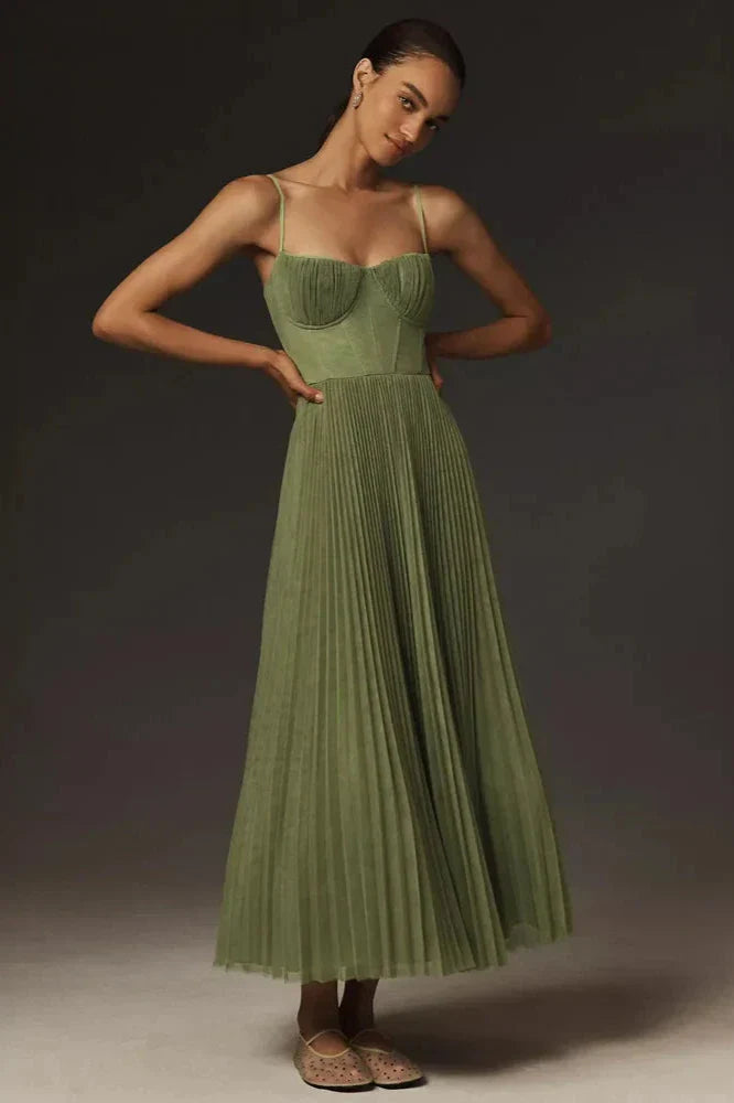 Front view, model wearing a green pleated tulle fit and flare midi dress with a sweetheart neckline and thin straps