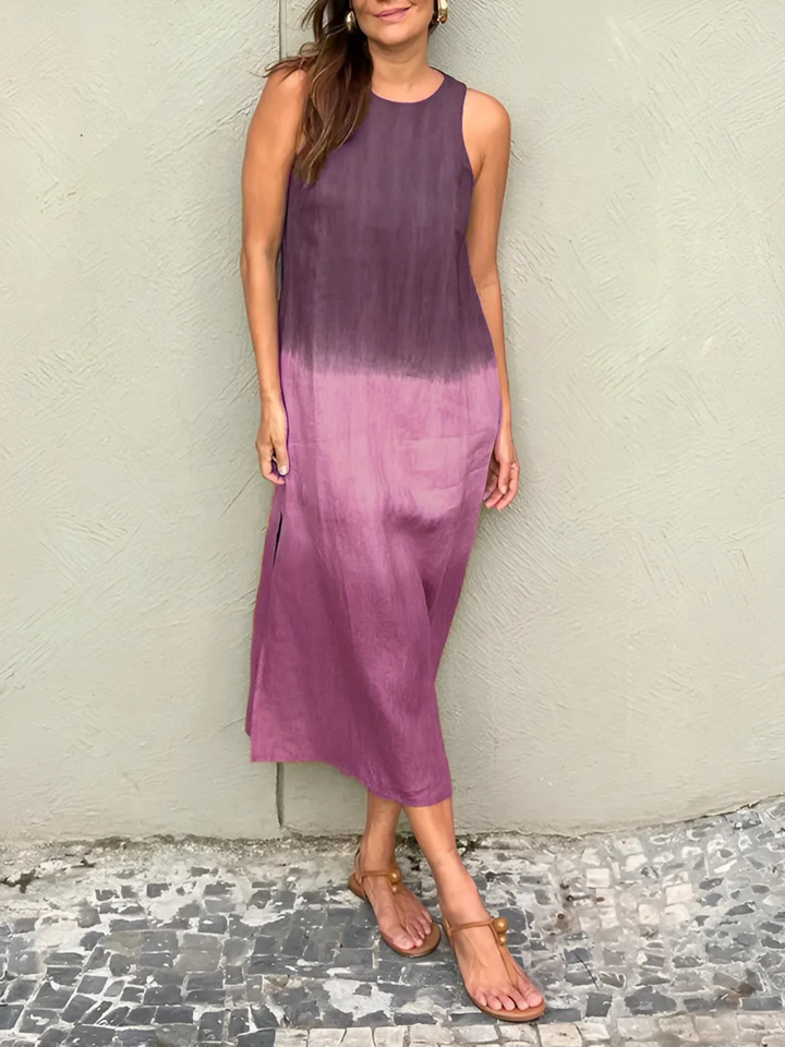 Willa Printed Dress worn by model, a sleeveless midi dress with a dark purple to light purple ombre print and sandals