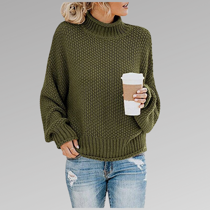 Front view of model wearing the green Jovana Airy Touch Knit top with ripped jeans and holding a coffee cup
