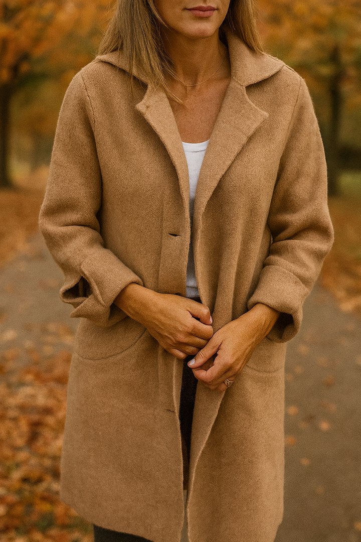 Close up view of the Madison Elegant Mid-Season Jacket in camel, worn by a model with hands clasped