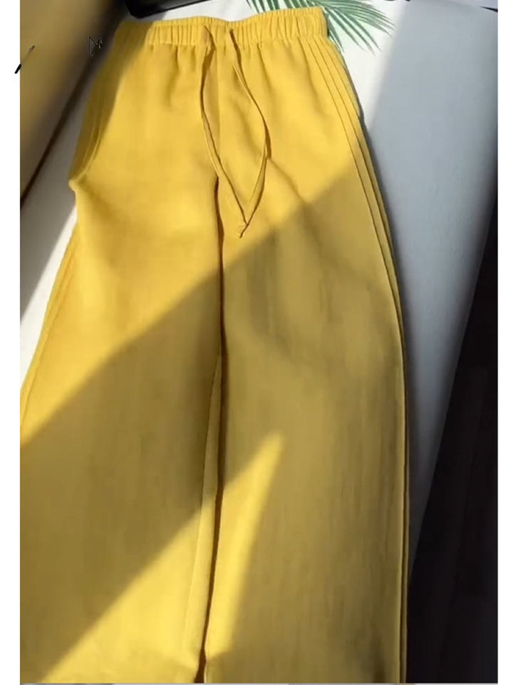 Close up of yellow Tencel linen wide leg casual pants with a drawstring and elasticated waist