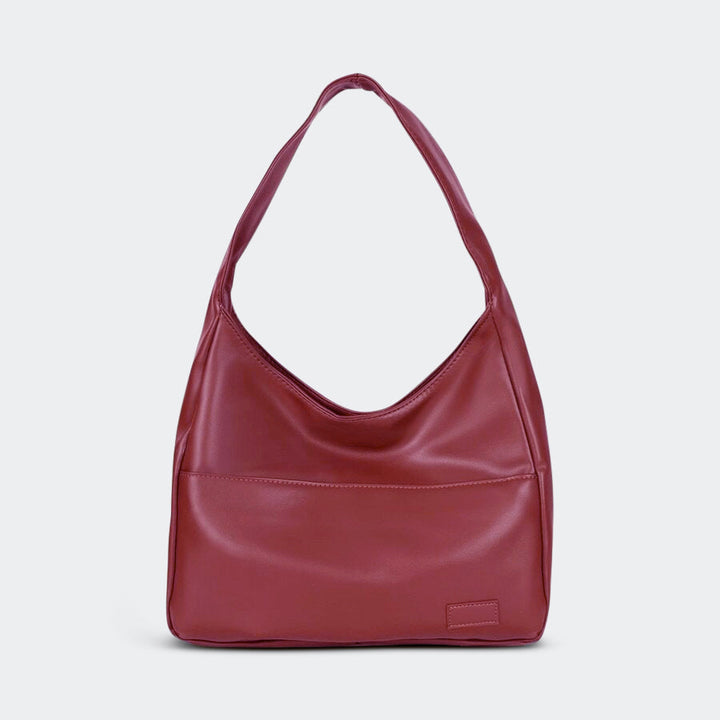 Front view of a spacious red PU leather shoulder bag with a single strap and a subtle front pocket