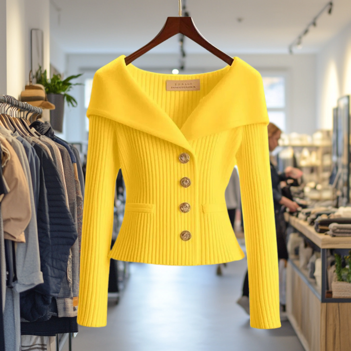Front view of the yellow Priscilla Cardigan in premium knit, hanging in a boutique with other clothing