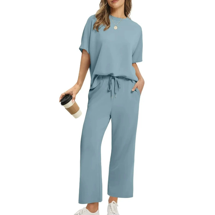 Front view, model wearing a comfortable two-piece casual top and pants set in blue with a coffee cup