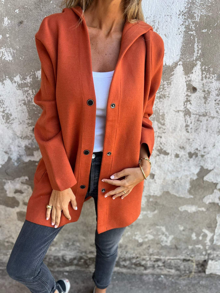 Burnt orange hooded casual jacket partly open with black buttons, front view