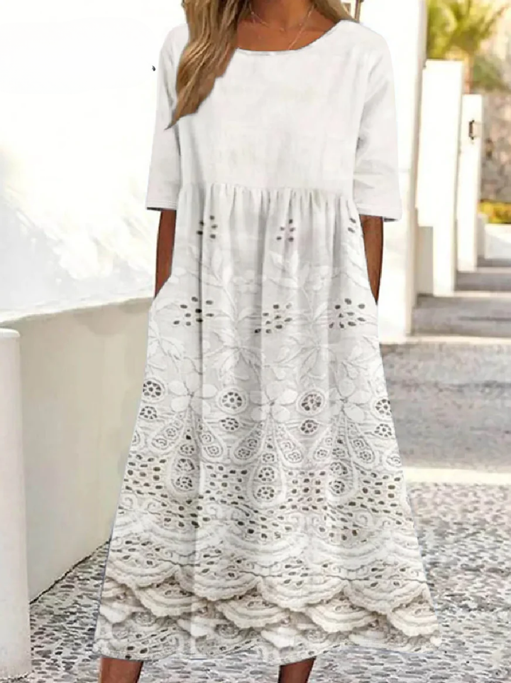 Front view of a model wearing the white vintage floral midi dress with pockets, featuring a round neck and lace trim