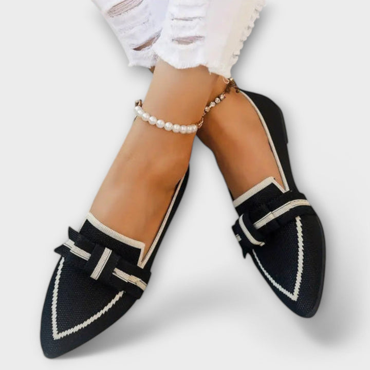 Black and white loafers with a knotted detail and a pearl anklet