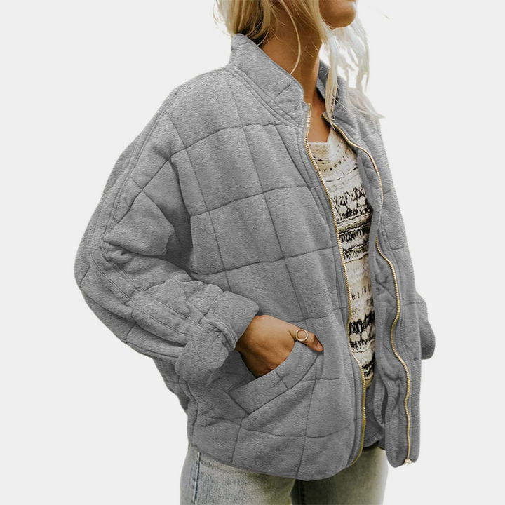 Close up view of the premium soft tailored jacket, worn by model, showing the elegant blazer with hand in pocket