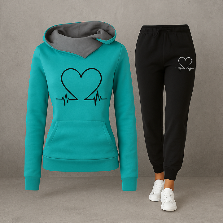 Front view, teal Heartbeat Tracksuit sweatshirt with black heart graphic and black joggers with white heart graphic
