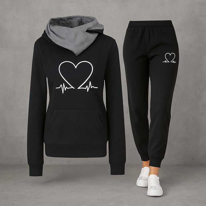 Front view, black Heartbeat Tracksuit sweatshirt with white heart graphic and black joggers with white heart graphic