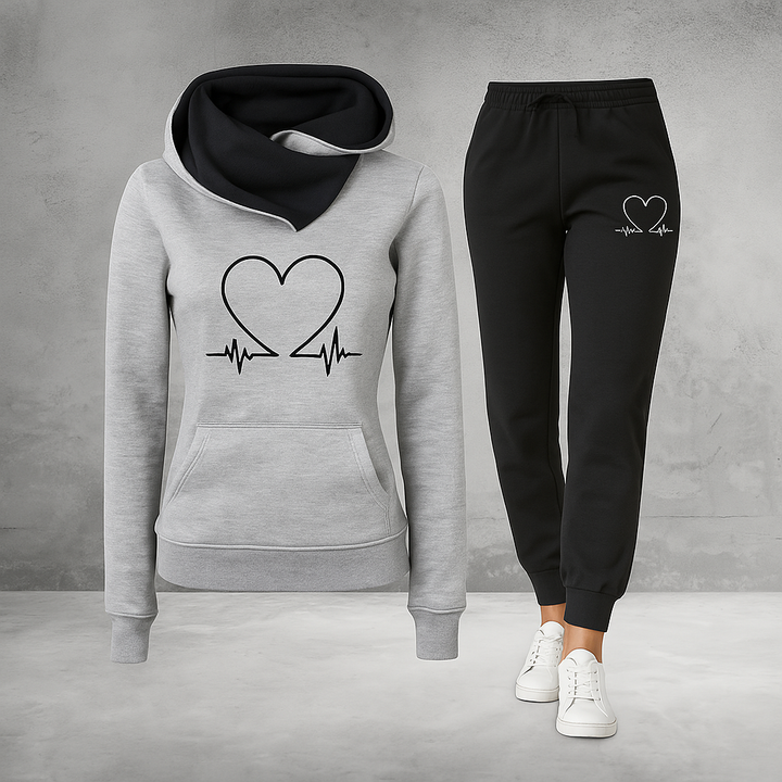 Front view, grey Heartbeat Tracksuit sweatshirt with black heart graphic and black joggers with white heart graphic