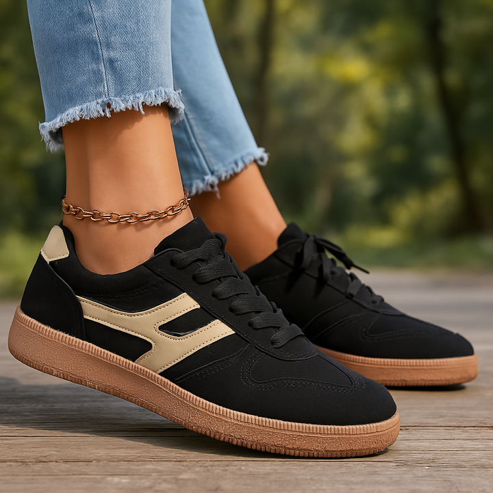 Ulani orthopedic comfort shoes worn by model, side view, black and tan with gum sole and anklet