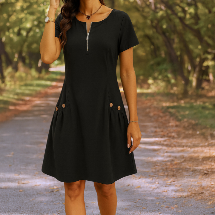 Close up front view of the black Millie summery dress with zip detail and decorative buttons on pockets